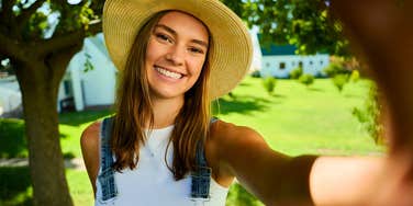 southern woman taking a selfie outside on the farm