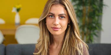 superficial woman sitting in her living room judging others