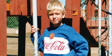 vintage 1980s childhood photo of young boy on playground wearing retro sweatshirt, nostalgic outdoor scene