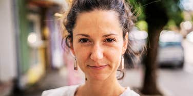 self-assured woman standing alone on a city street