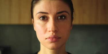 cold-hearted woman staring blankly