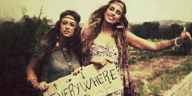 A nostalgic scene of hippies hitchhiking on a sunny road in the 1970s, illustrating the original spirit of activism and freedom that defined the early lives of many Baby Boomers.