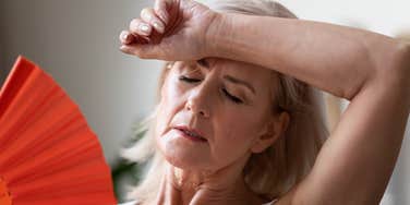 Woman has menopause symptoms.