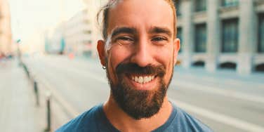 grown adult man smiling taking care of responsibilities 