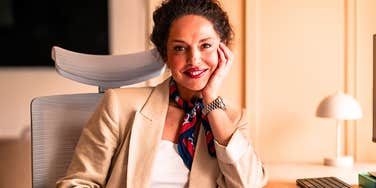 Truly authentic woman sits confidently at a desk 