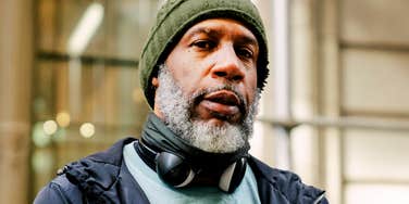 A portrait of a mature man outdoors in winter clothing, representing the 'functional loneliness' and the specific personality traits that prevent deep male bonding.