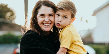 A mother and young child sharing a playful and affectionate moment