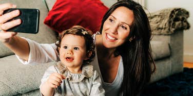 A mother and child sharing a digital moment, capturing the widely accepted behavior of posting children on social media.