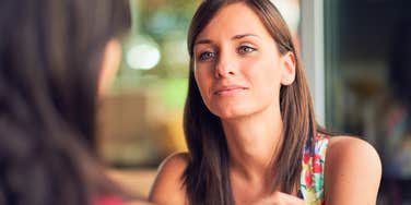 woman talking to fake person making her feel physically uncomfortable