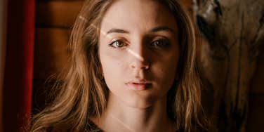 Woman staring directly at the camera with a concerned expression, illustrating signs of confusion and unease in a relationship that shouldn’t be ignored