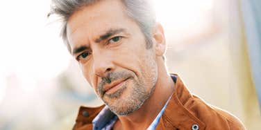 Portrait of a happy mature man in a city, capturing the vibrant and stress-free lifestyle possible in your sixties with the right psychological tools.