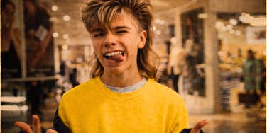A vintage 1980s photo of a teenager at a mall sticking out her tongue and winking, illustrating the 'Gen-X attitude' and the rebellious spirit of Eighties youth culture.
