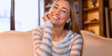 high-value woman at home getting excited about normal things
