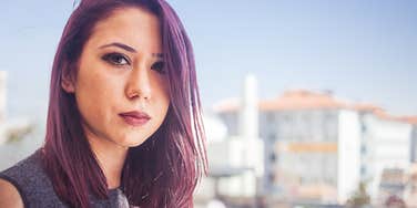 Young woman who isn't a good friend looks sharply at the camera