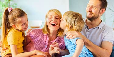 loving family sitting together on couch after parents made sacrifices