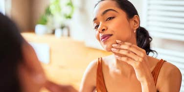 woman in the bathroom looking in mirror refusing to do unhygienic things