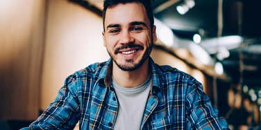 Lone wolf man smiling in a restaurant alone 