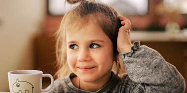 Young girl smiling gently, illustrating the quiet strength that can develop in kids raised to choose kindness even when it’s difficult