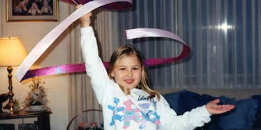 Retro 1980s photo of a young girl in Minneapolis twirling a ribbon baton, symbolizing nostalgic childhood traits rarely seen today