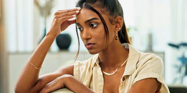 sad pensive woman whose parents unfairly criticized her growing up