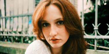 A woman with a steady, intense gaze, capturing the quiet strength and hyper-awareness that can be transformed into valuable life skills and emotional intelligence.