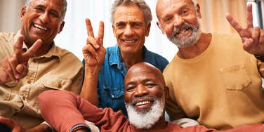 older men who have been friends since high school hanging out smiling