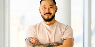 confident happy man with tattoos smiling 