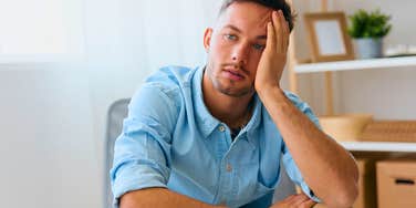 man sitting home alone with few friends and no social plans