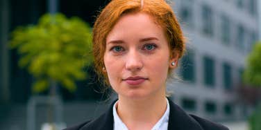 assertive gen z worker standing outside her office