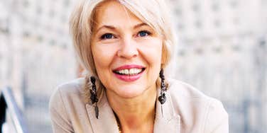 Beautiful middle-aged woman smiling confidently, illustrating healthy habits that help people in their fifties and sixties age well