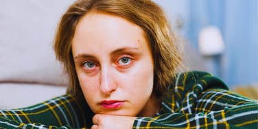 Woman who gets in the way of her own success looking defeated