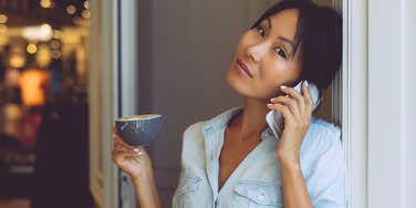 Woman who is never fooled by fake people holding tea in her home