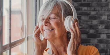 older woman listening to music with headphones