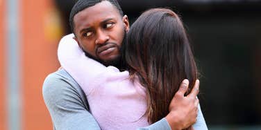 man who can't stand being hugged in a reluctant embrace