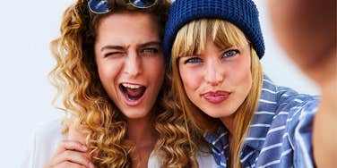 two happy best friends taking a selfie together