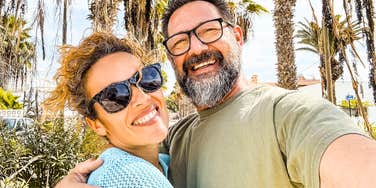Happy middle-aged couple smiling together, illustrating how couples in their fifties and sixties reconnect by sharing meaningful life memories