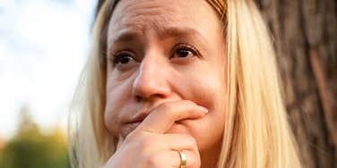 A somber woman on the verge of tears, illustrating the difficult and often silent realization that a relationship's dynamic has shifted over time.