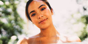 A close-up portrait of a woman with a kind, sensitive face and a soft gaze, illustrating the deep empathy and emotional intelligence that Highly Sensitive People bring to relationships.