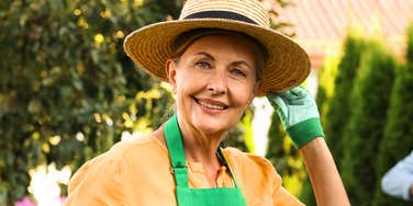 Gardening as a therapeutic hobby: A mature woman enjoying outdoor gardening, representing the simple, old-fashioned habits that contribute to better cardiovascular wellness