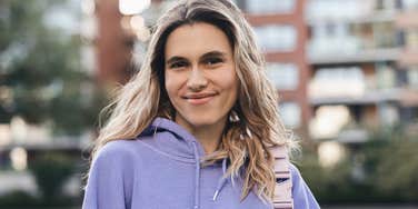 Unintentionally charming woman smiling outside