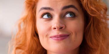 smirking woman who is not a good person despite acting nice