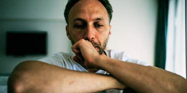 A portrait of a mature man with a pensive and sorrowful expression, representing the 'search for closure' and the emotional weight of missed opportunities.