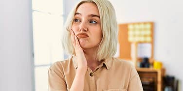 woman raised with zero manners looking distracted and annoyed