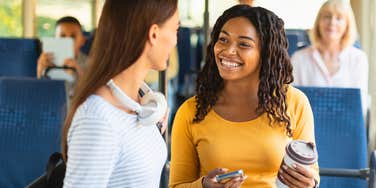woman riding a bus with stranger being unusually nice to her