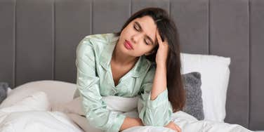 woman feeling tired in bed