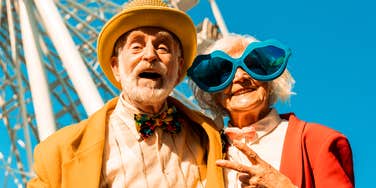 A mature couple laughing and having fun together, illustrating the science-backed power of daily habits—like social connection and play—that contribute to a happier life as we age