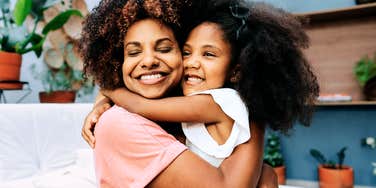 Mother and daughter embracing warmly, illustrating the lessons a parent teaches because the world won’t