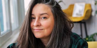 A mature woman looking thoughtful and healthy, representing the 'everyday habits' and neuro-protective choices that reduce the risk of cognitive decline.