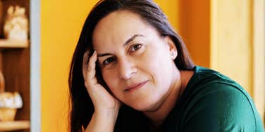 A portrait of a serene woman looking directly at the camera, representing the 'second adulthood' and the unexpected personal boundaries established in mid-life.