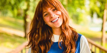 happy unbothered woman smiling outside